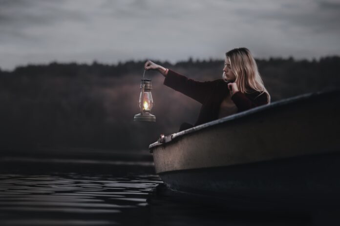 woman-on-a-boat-holding-gas-lantern-722427