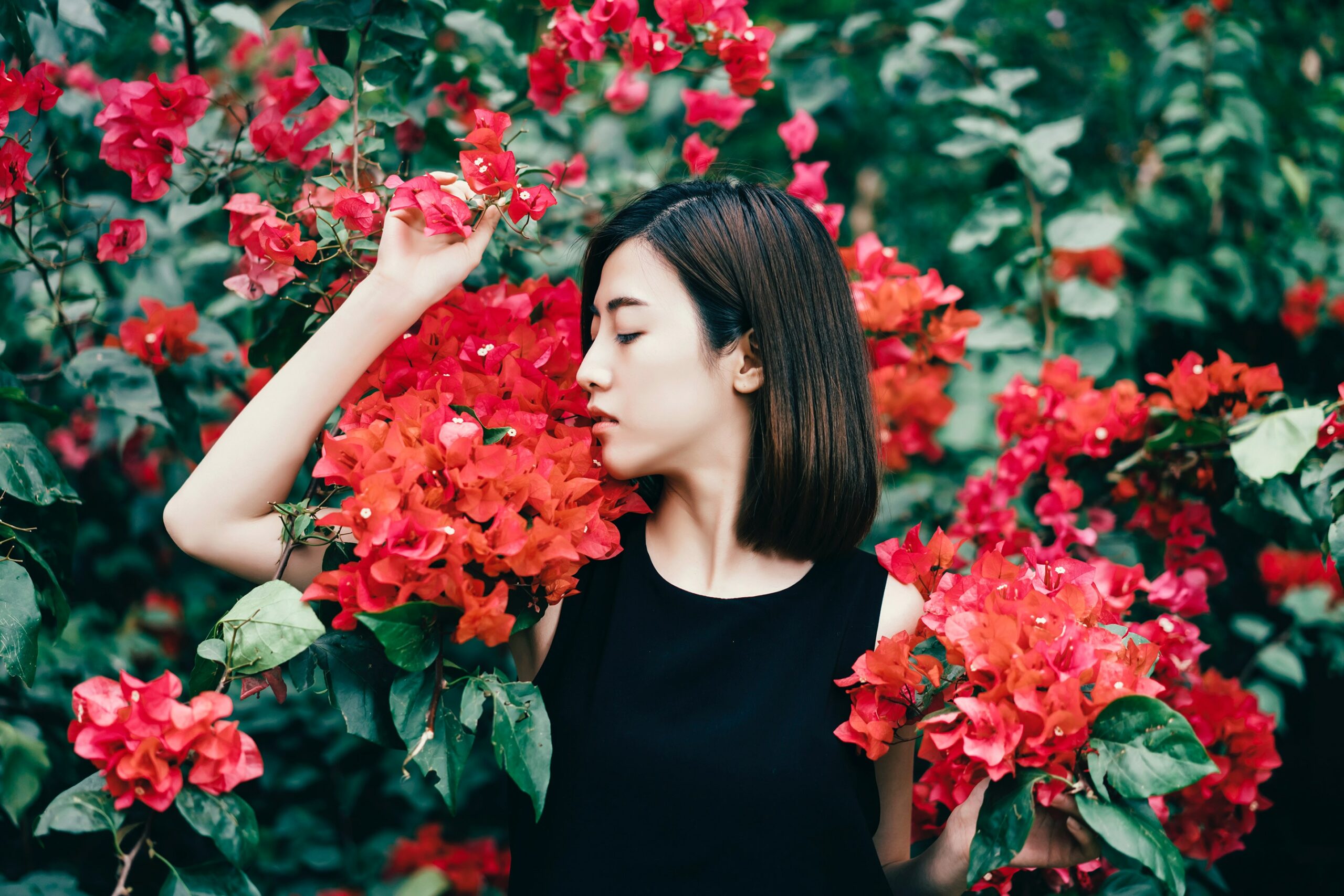 woman surrounded by pink flowers