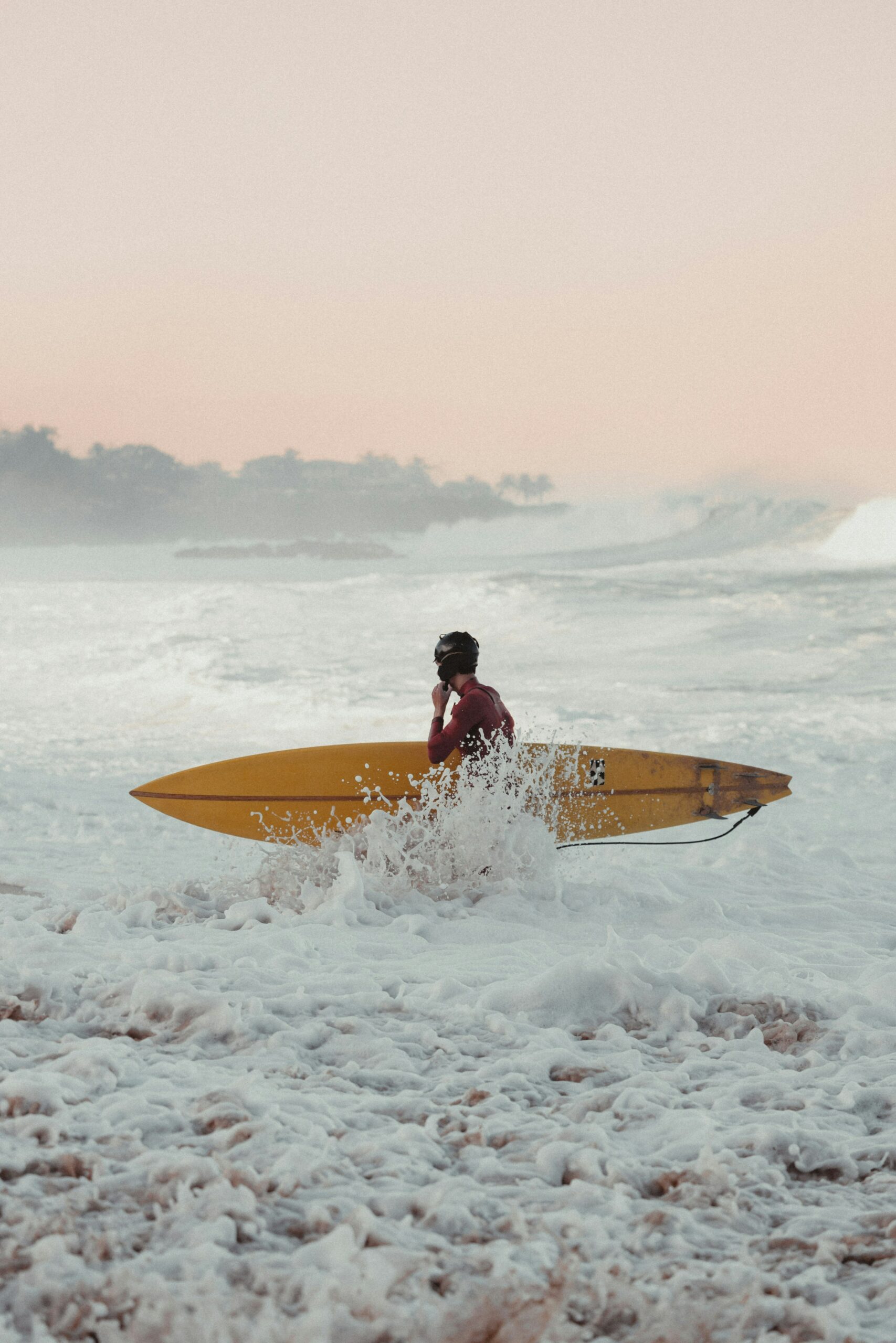 a man sitting on top of a surfboard in the ocean